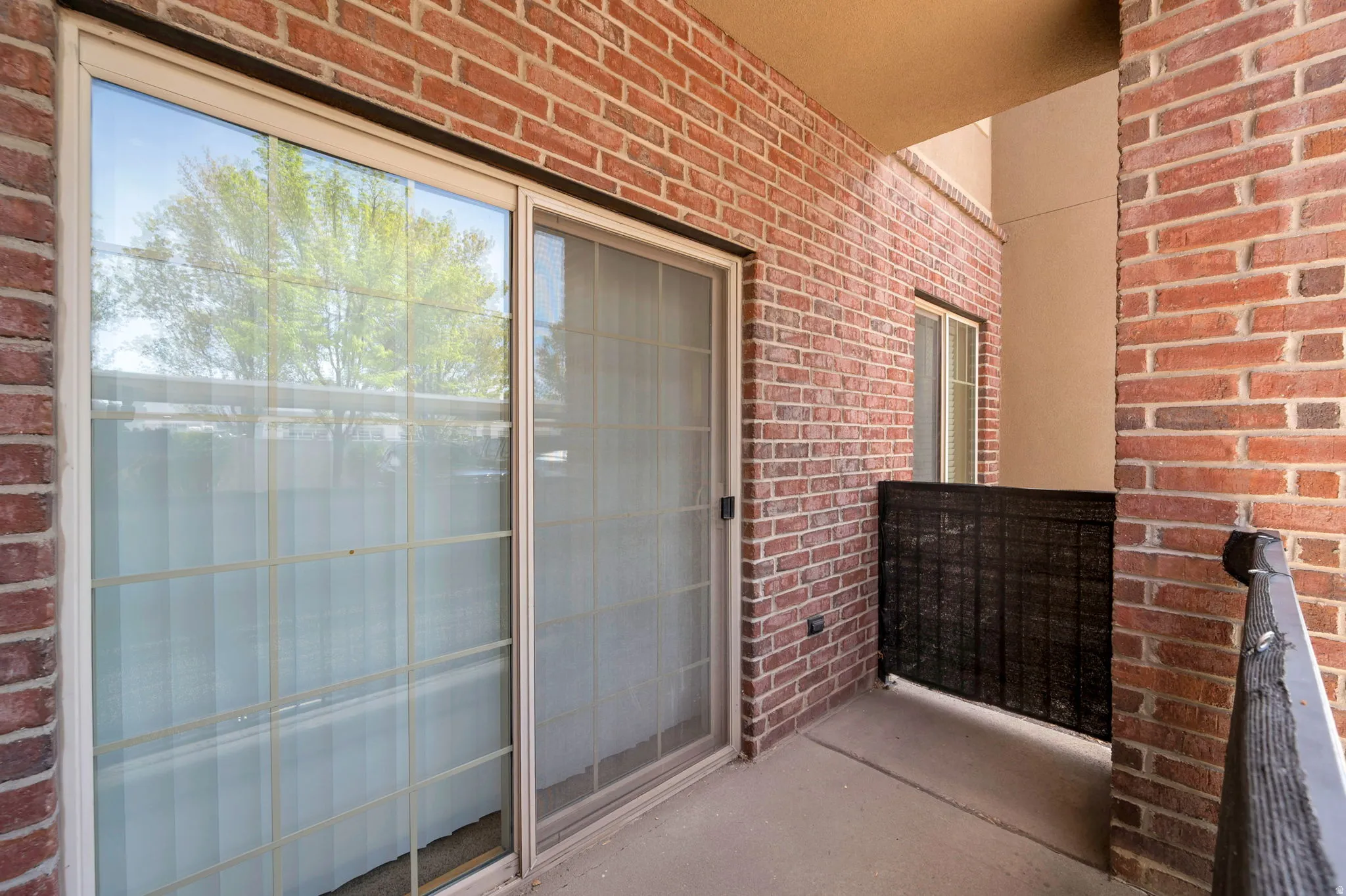 Entrance to property featuring brick siding