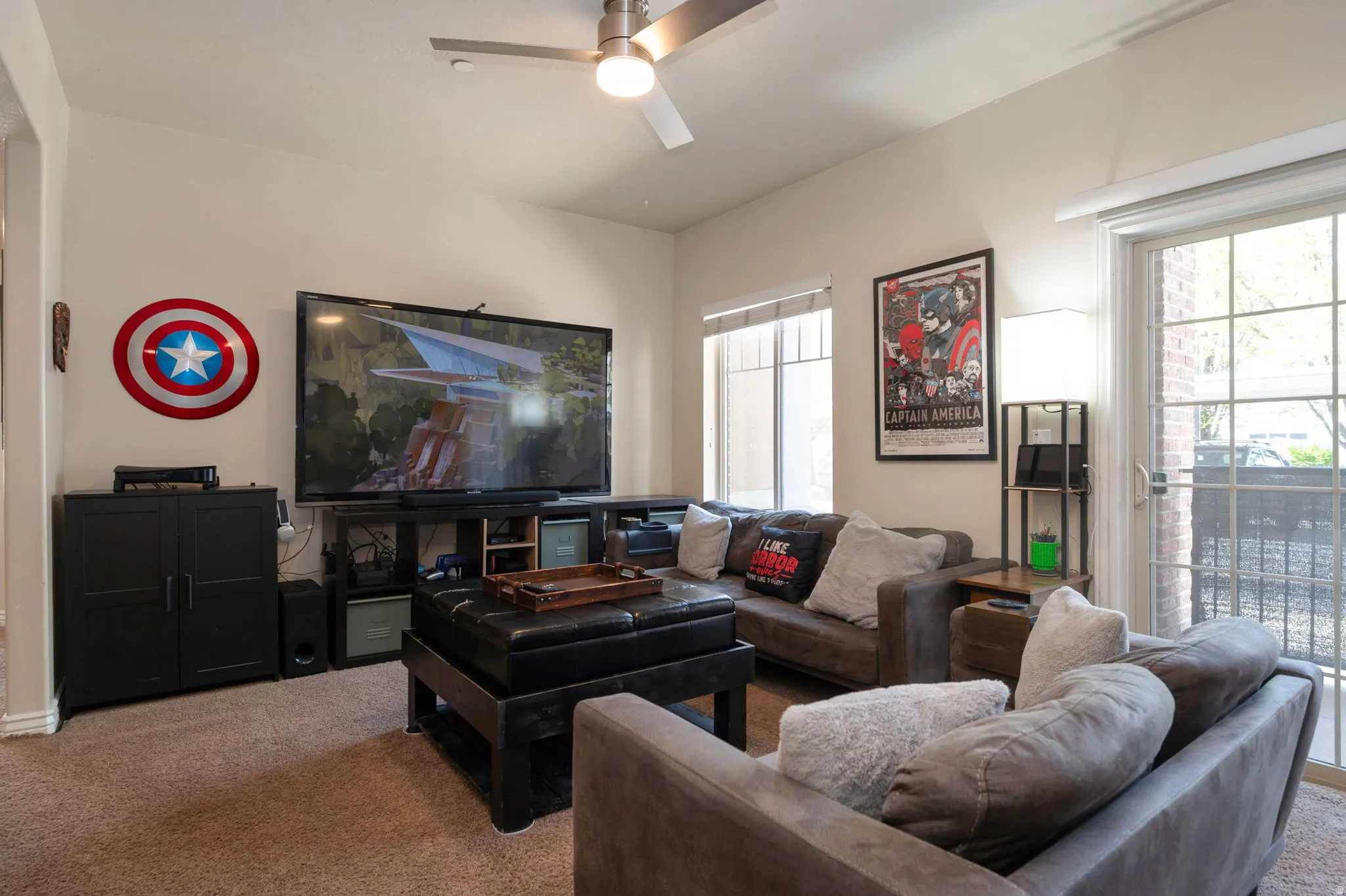 Living room with carpet flooring and a ceiling fan