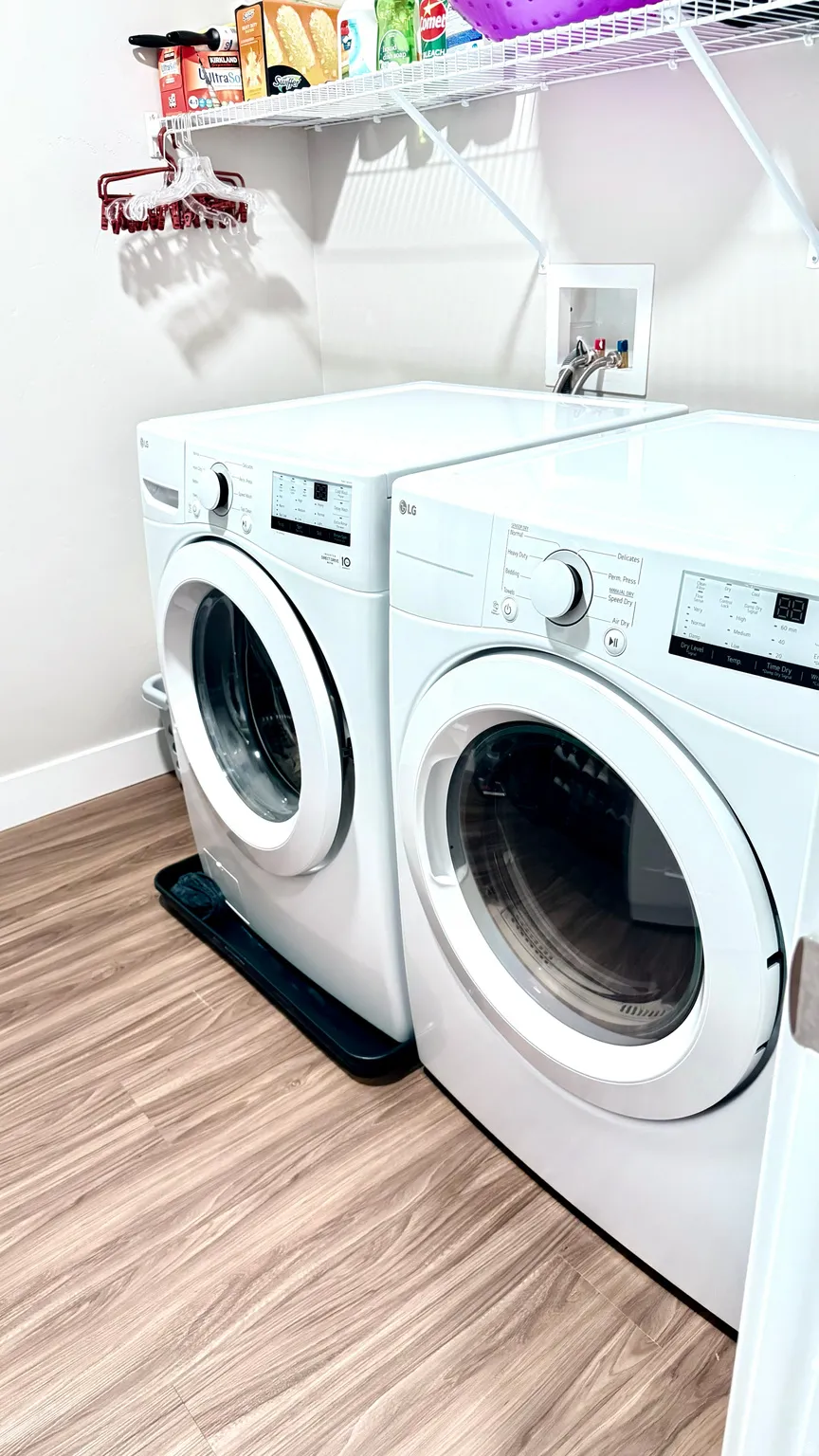 Laundry area featuring washer and clothes dryer and light wood-style floors