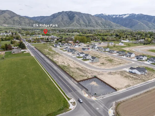 Aerial overview of property's location featuring mountains and nearby suburban area
