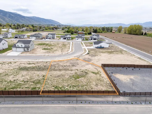 Aerial perspective of suburban area featuring a mountain backdrop and property boundaries highlighted