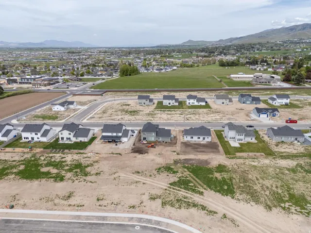 Aerial overview of property's location featuring nearby suburban area and a mountainous background