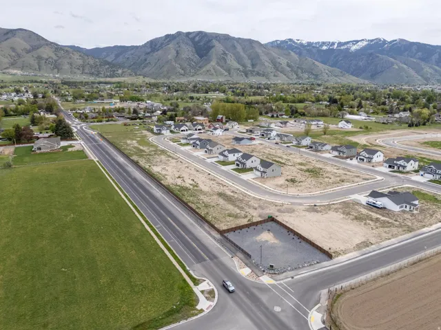 Aerial view of property's location with a mountainous background and nearby suburban area