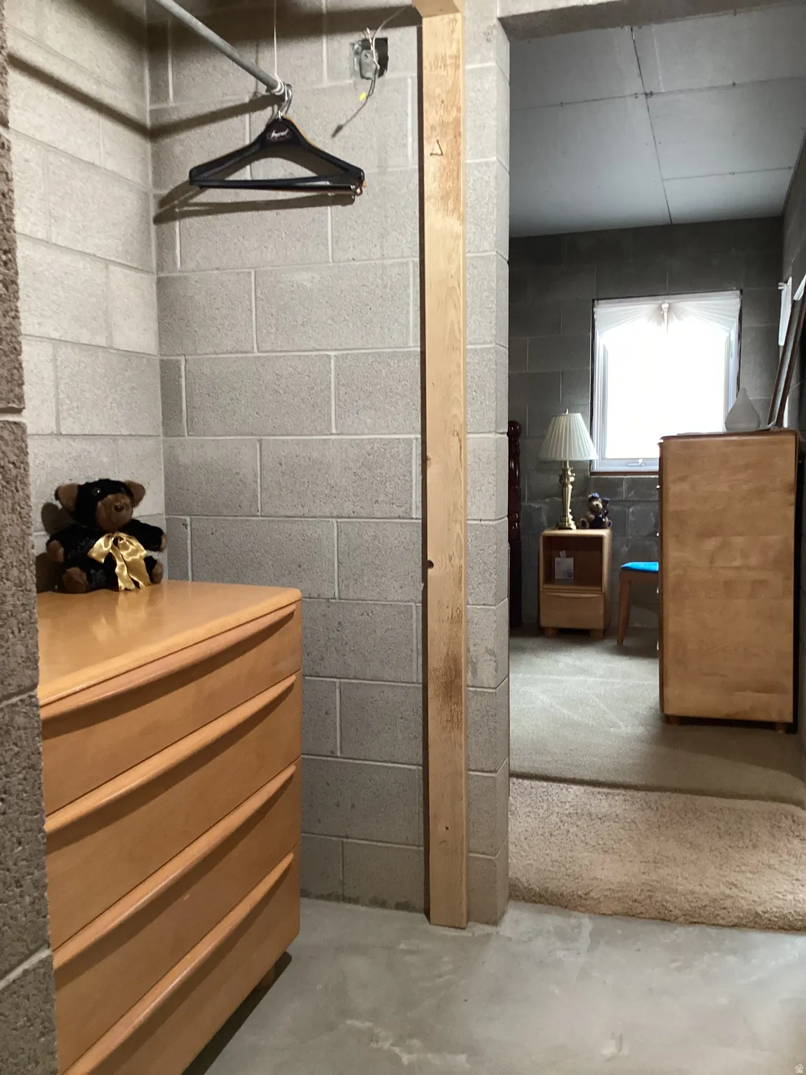 Bathroom with concrete block wall and concrete flooring