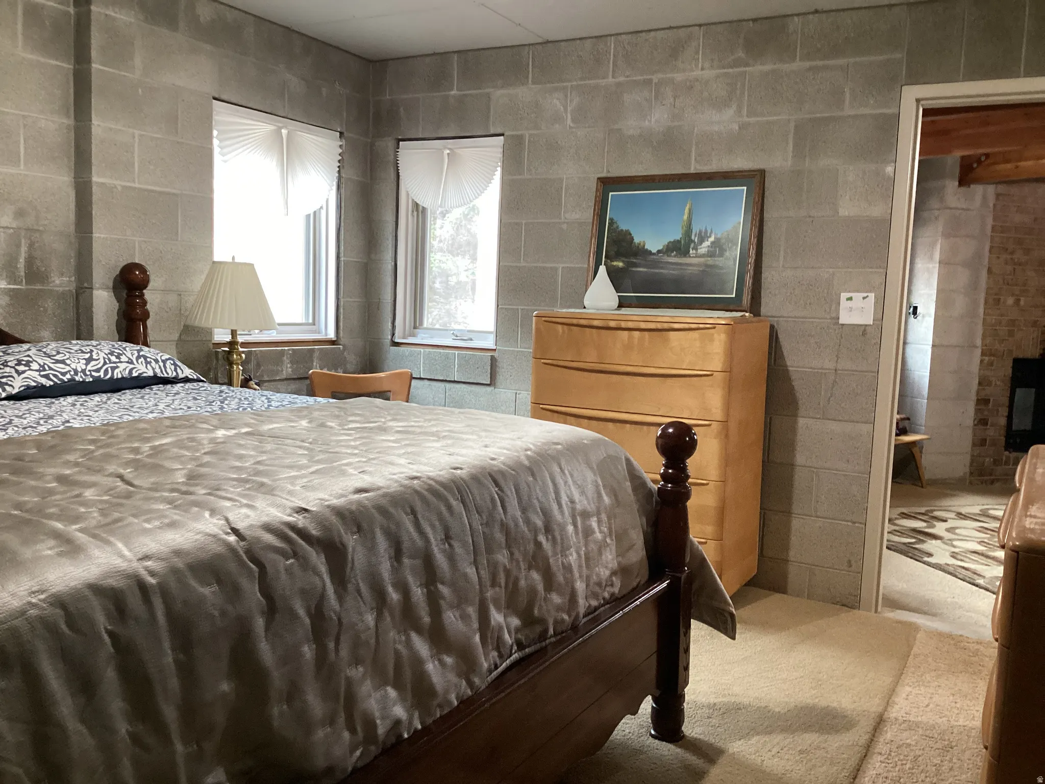 Bedroom featuring concrete block wall