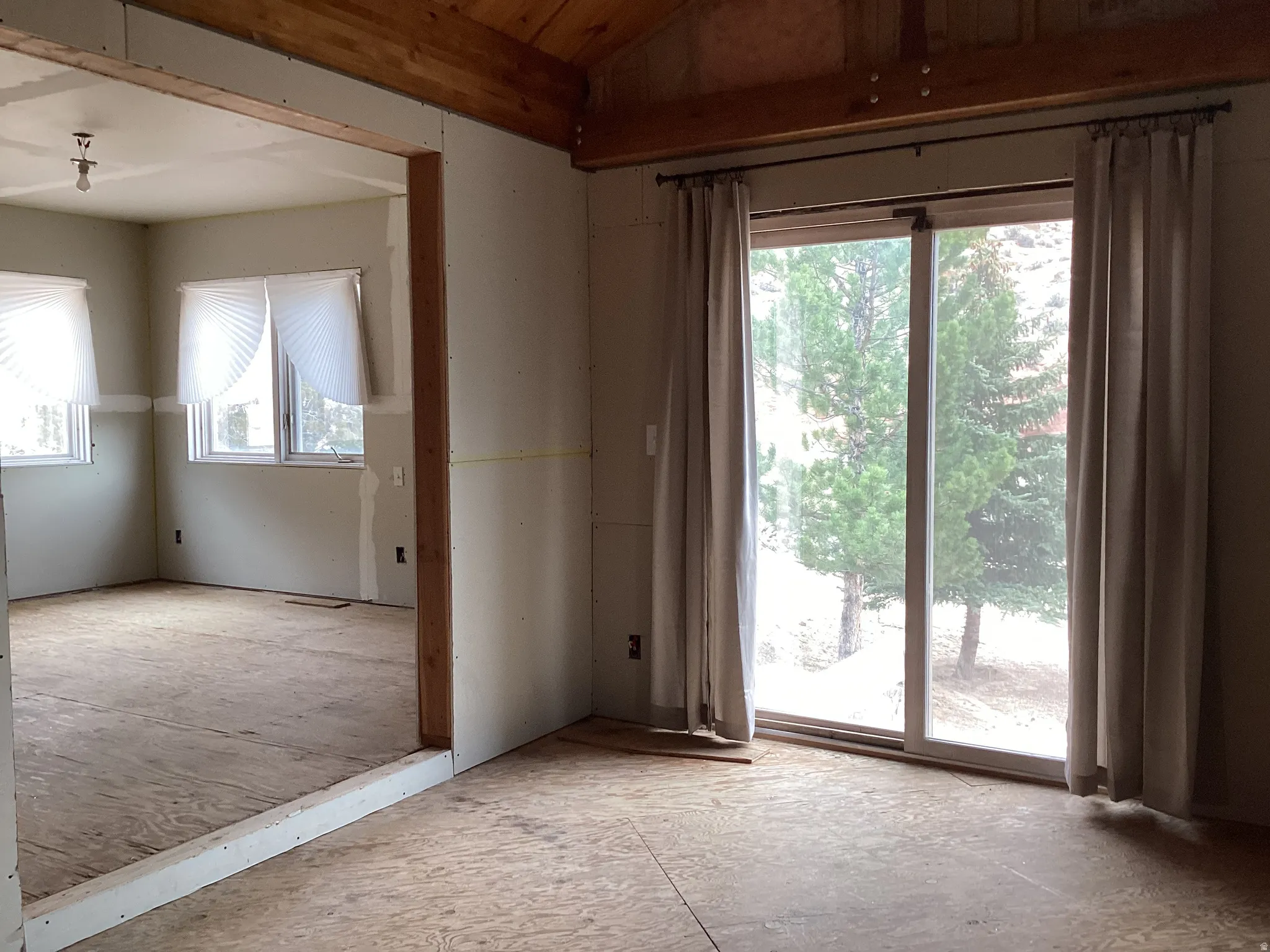 Unfurnished room with lofted ceiling