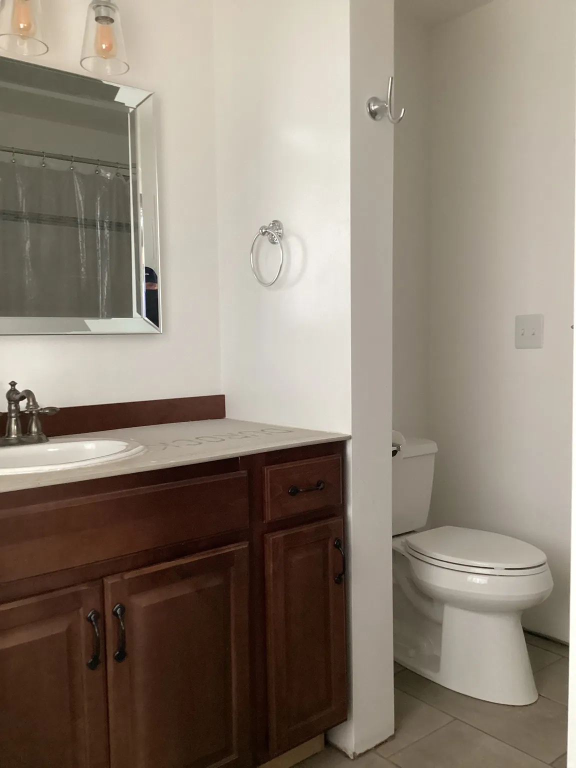 Bathroom featuring vanity, light tile patterned floors, and a shower with shower curtain