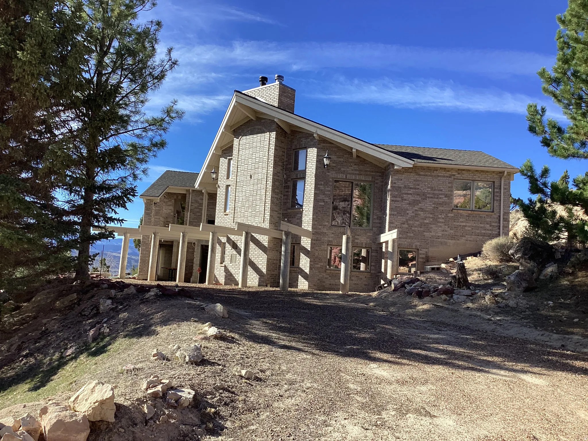 View of property exterior with brick siding and a chimney