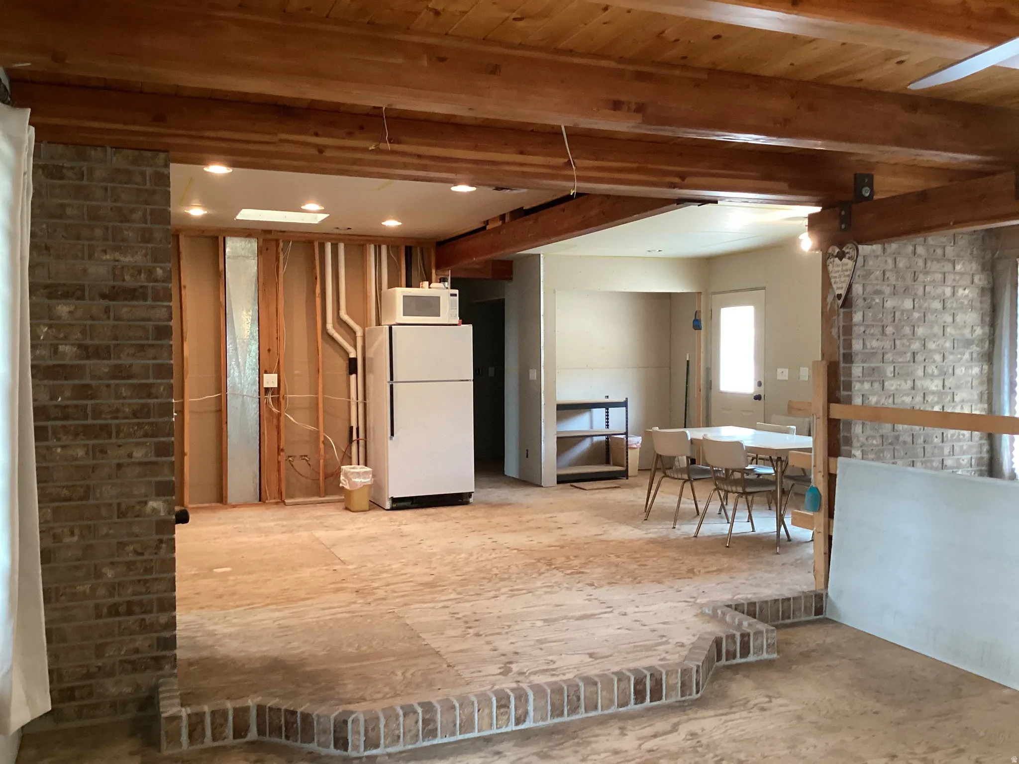 Below grade area with freestanding refrigerator