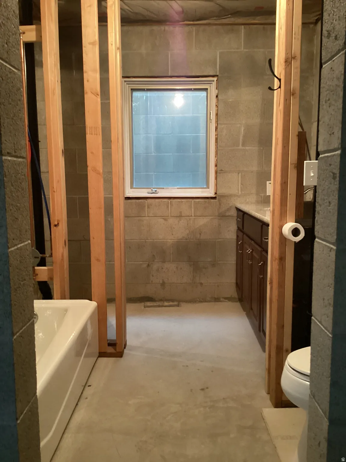 Bathroom featuring vanity and concrete flooring
