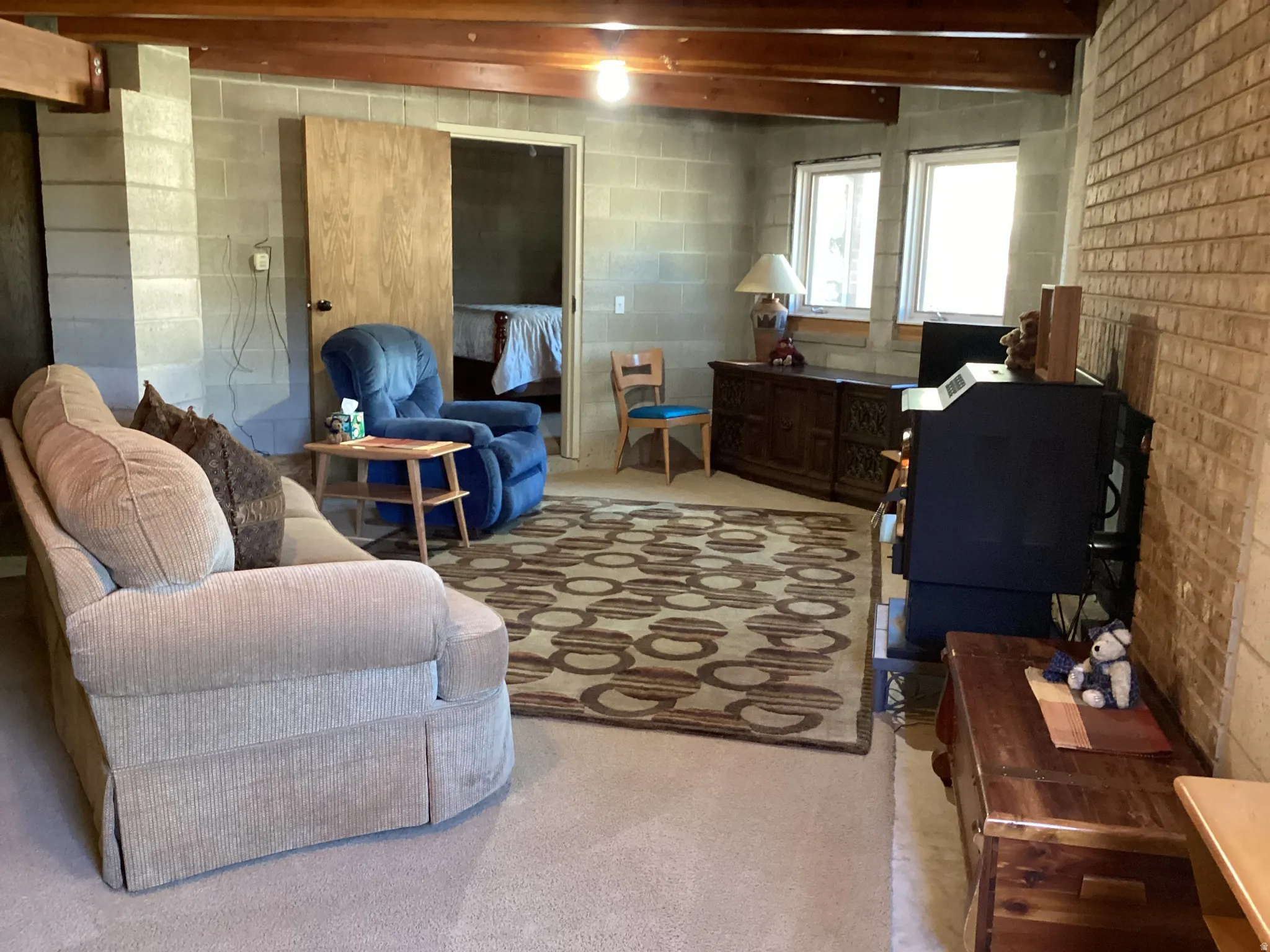 Living room featuring concrete block wall