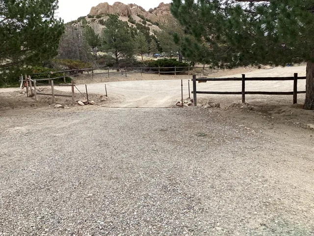 View of dirt / gravel road featuring a gate and a mountain view