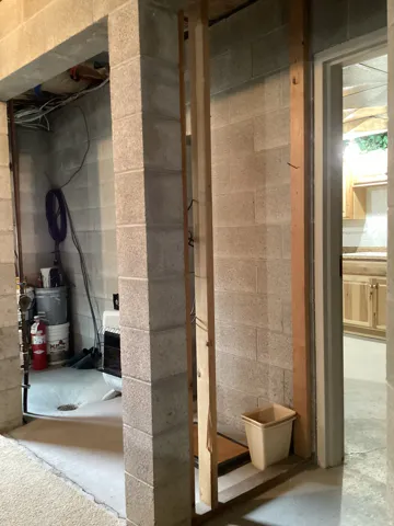 Bathroom with unfinished concrete flooring