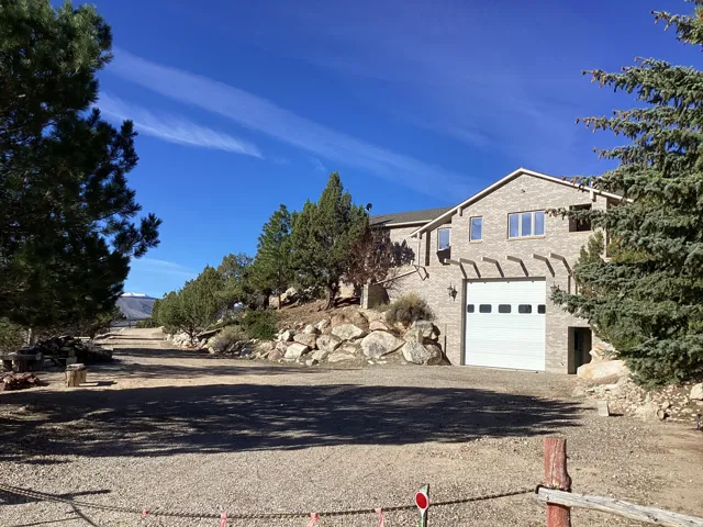 View of front of property featuring a garage and driveway