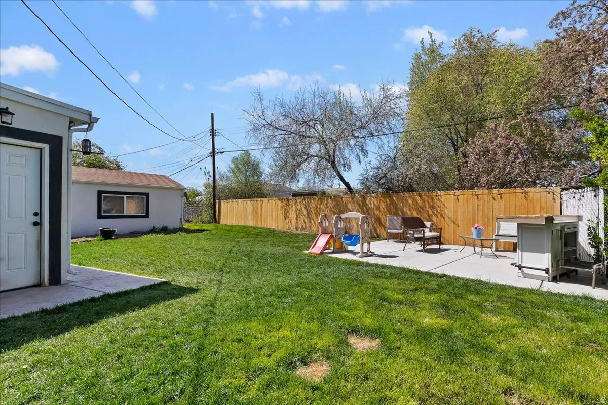 Fenced backyard with a patio area