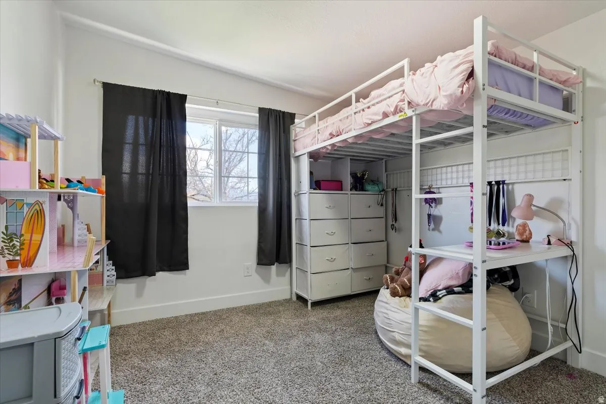 Carpeted bedroom with baseboards