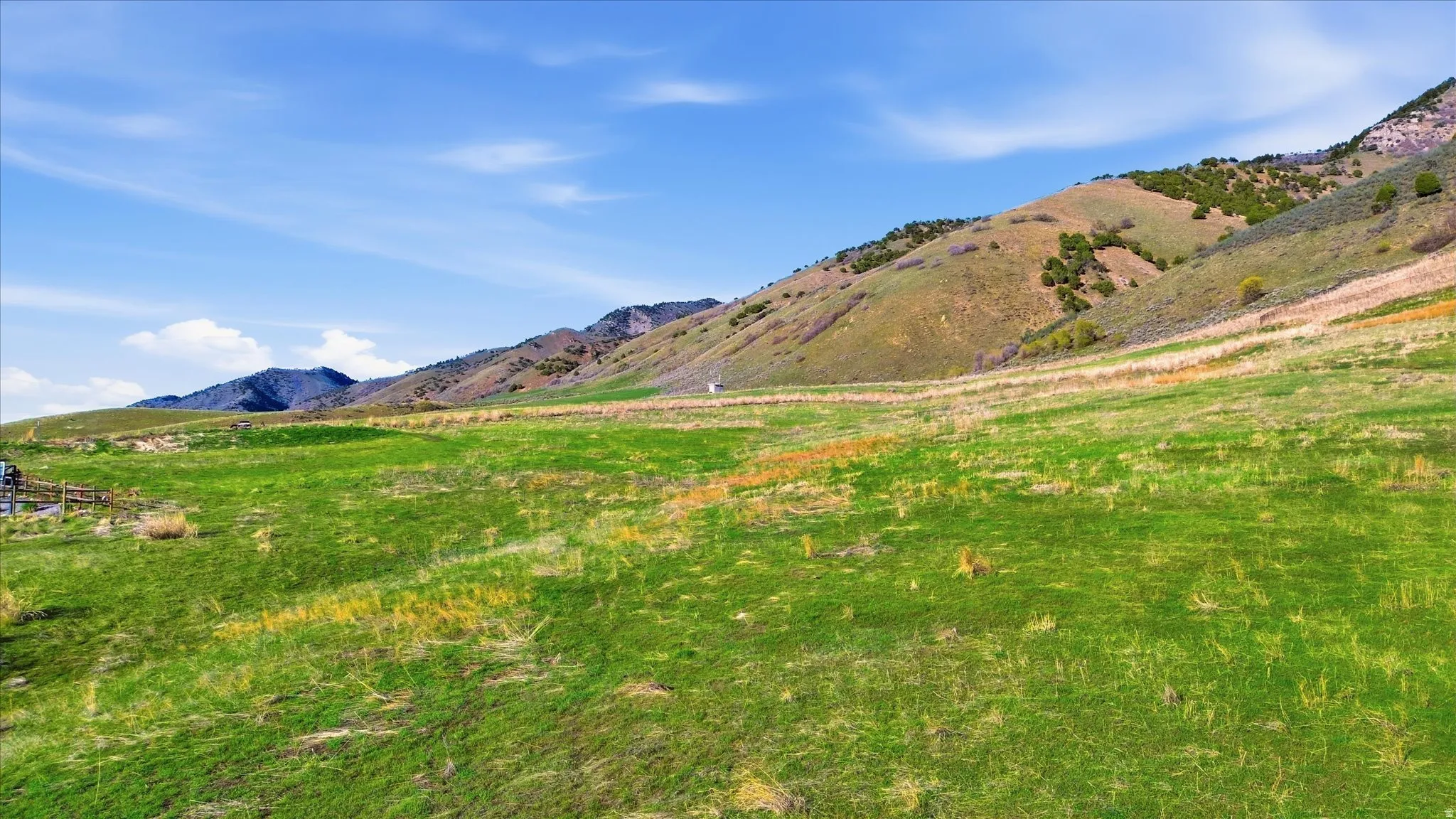 View of mountain backdrop with rural landscape and agricultural land