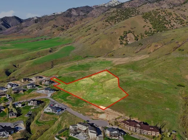 Aerial overview of property's location featuring property boundaries highlighted and a mountain backdrop