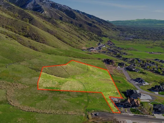 Aerial view of property's location with property parcel outlined and a mountain backdrop