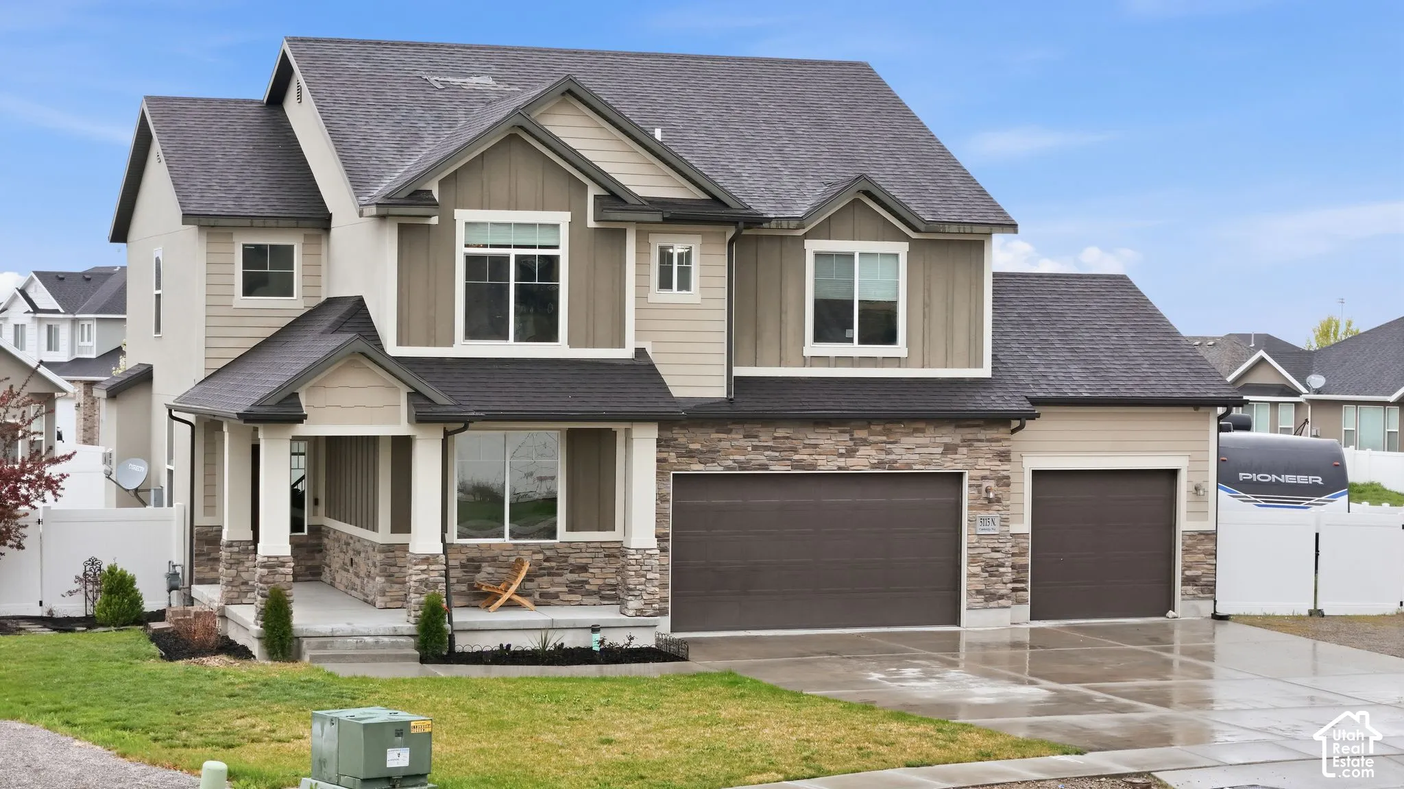 Craftsman-style home with driveway, board and batten siding, stone siding, roof with shingles, and an attached garage