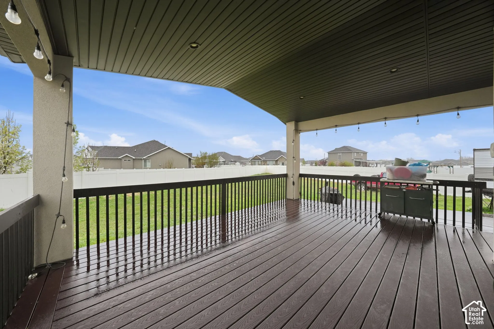 Deck with a fenced backyard and a residential view