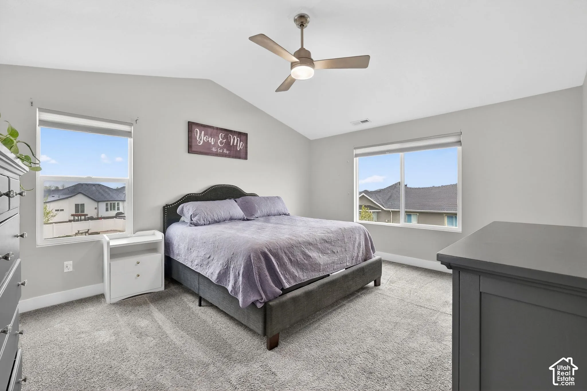 Bedroom with light carpet, vaulted ceiling, and ceiling fan