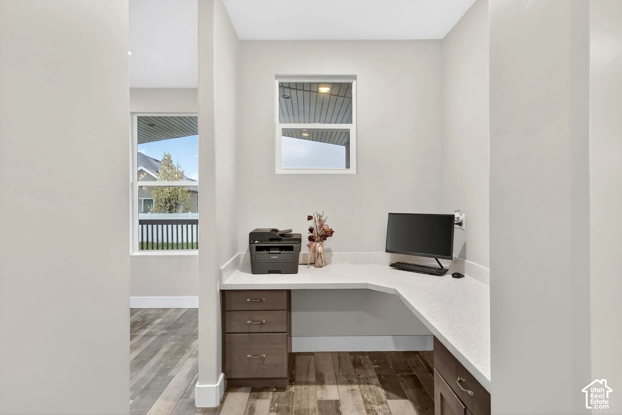 Home office featuring built in study area and light wood-type flooring