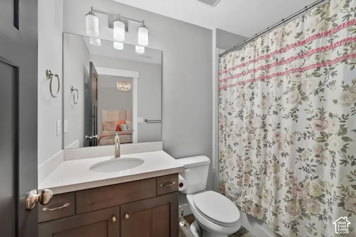 Ensuite bathroom featuring vanity and toilet