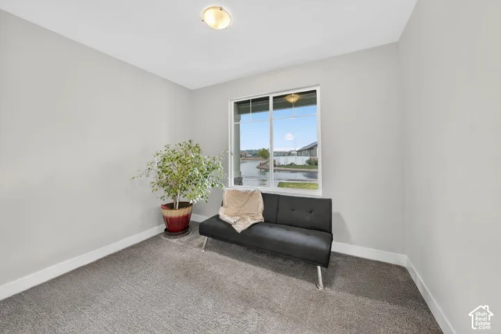 Living area with carpet floors and a water view