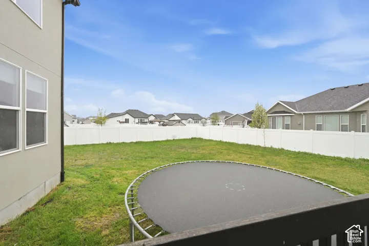 Fenced backyard with a residential view