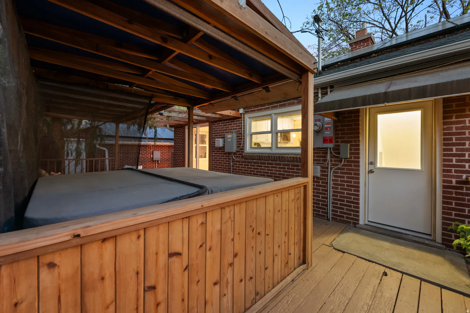 Wooden terrace featuring a hot tub