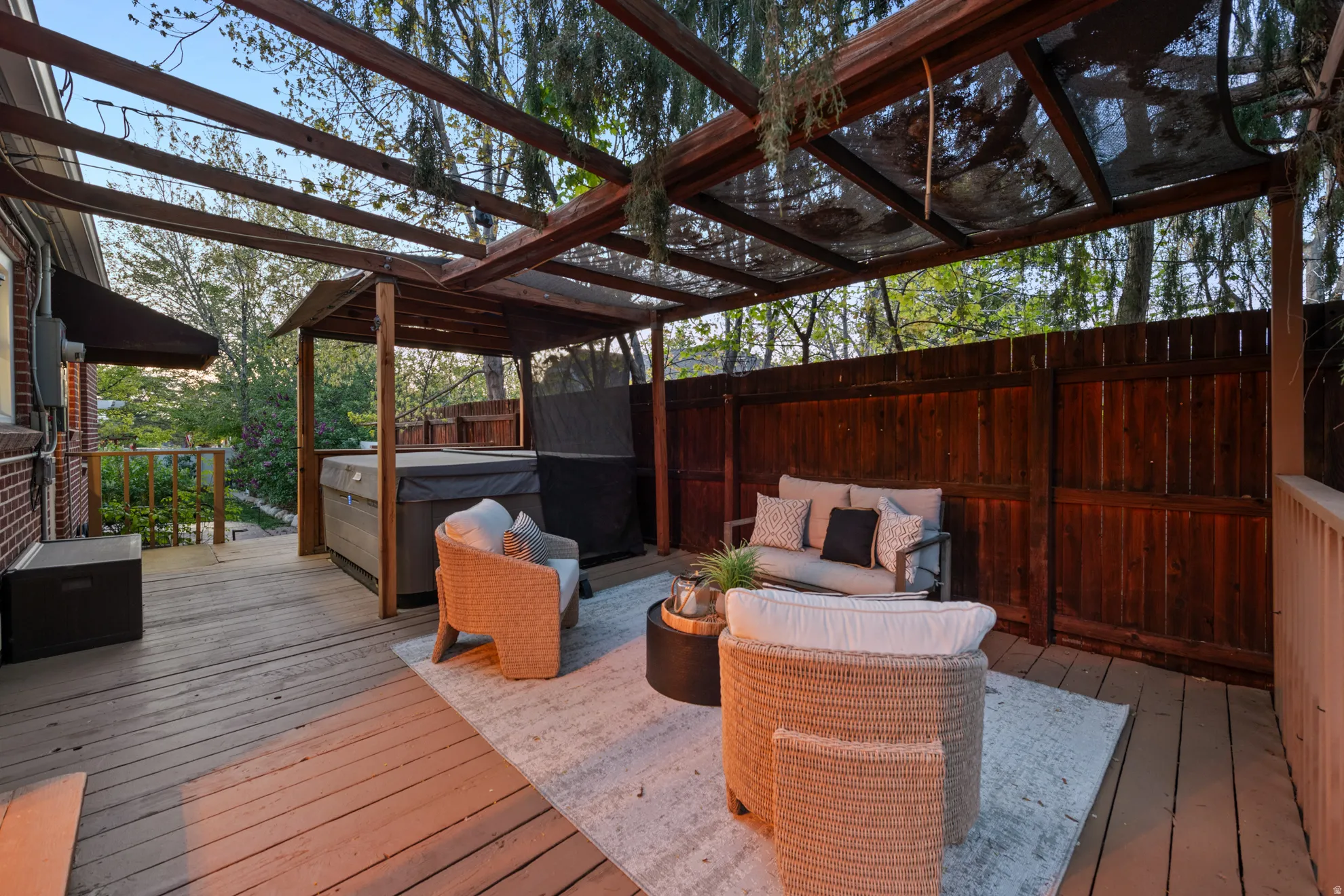 Deck with a hot tub, outdoor seating, and grilling area