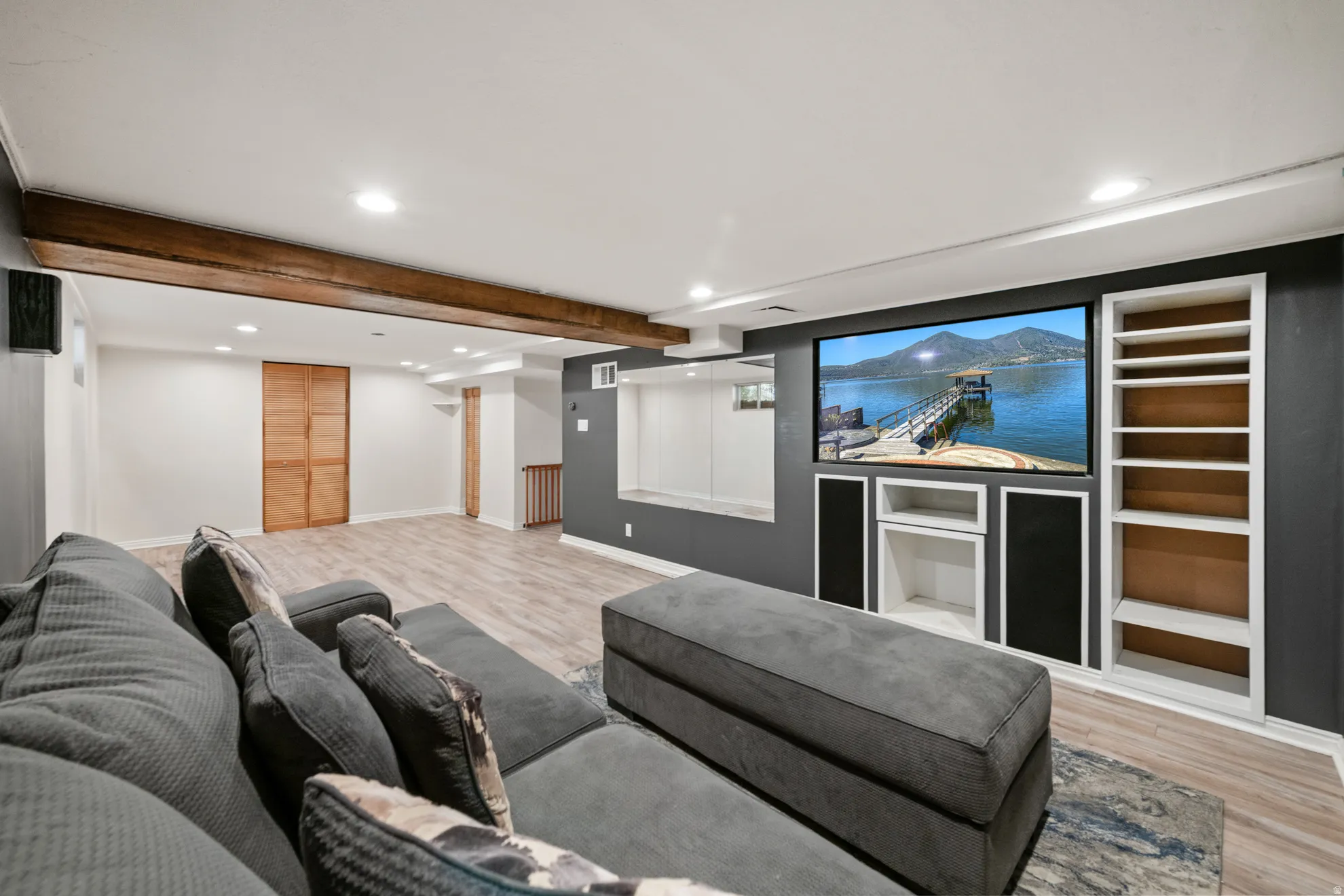 Cinema featuring recessed lighting, light wood-style flooring, and beamed ceiling