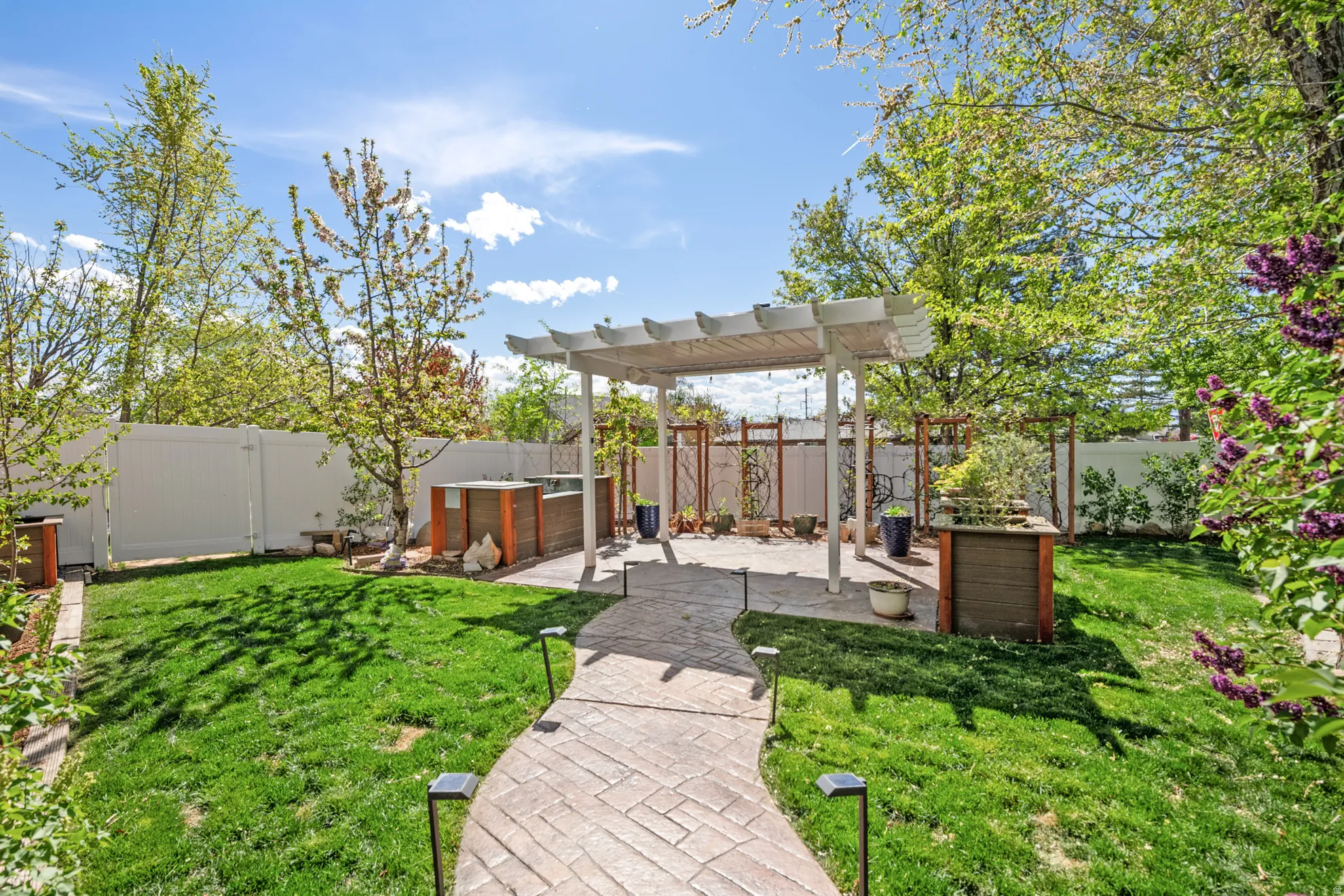 Fenced backyard featuring a patio area and a pergola
