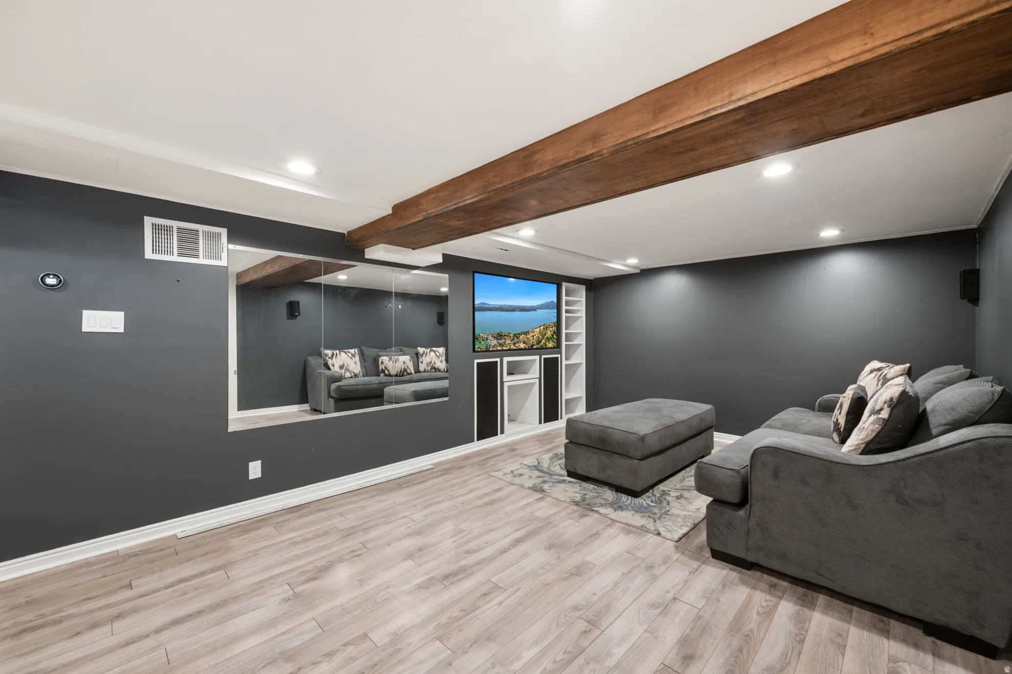 Home theater room featuring beamed ceiling, recessed lighting, and light wood-type flooring