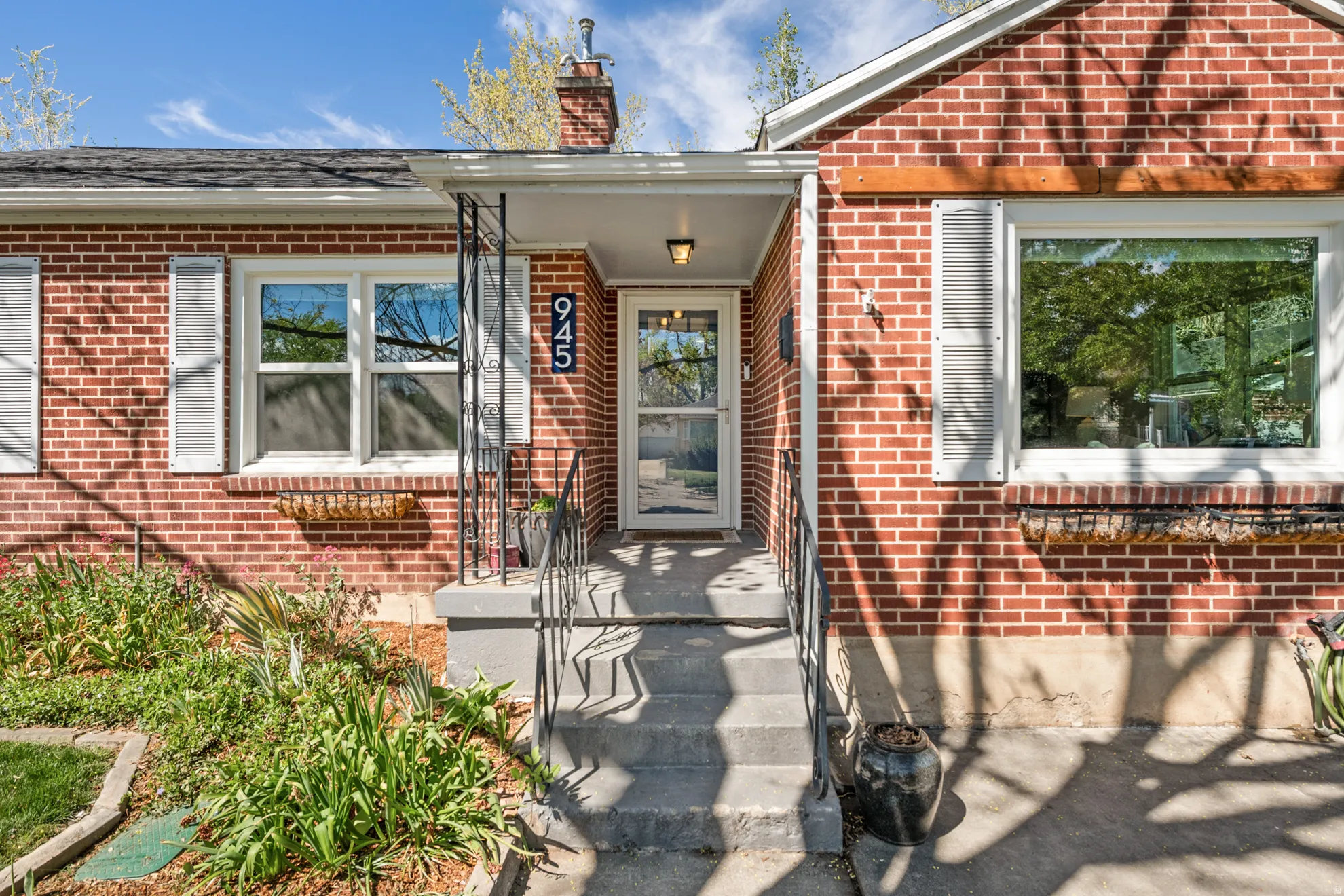 Doorway to property featuring brick siding and a chimney