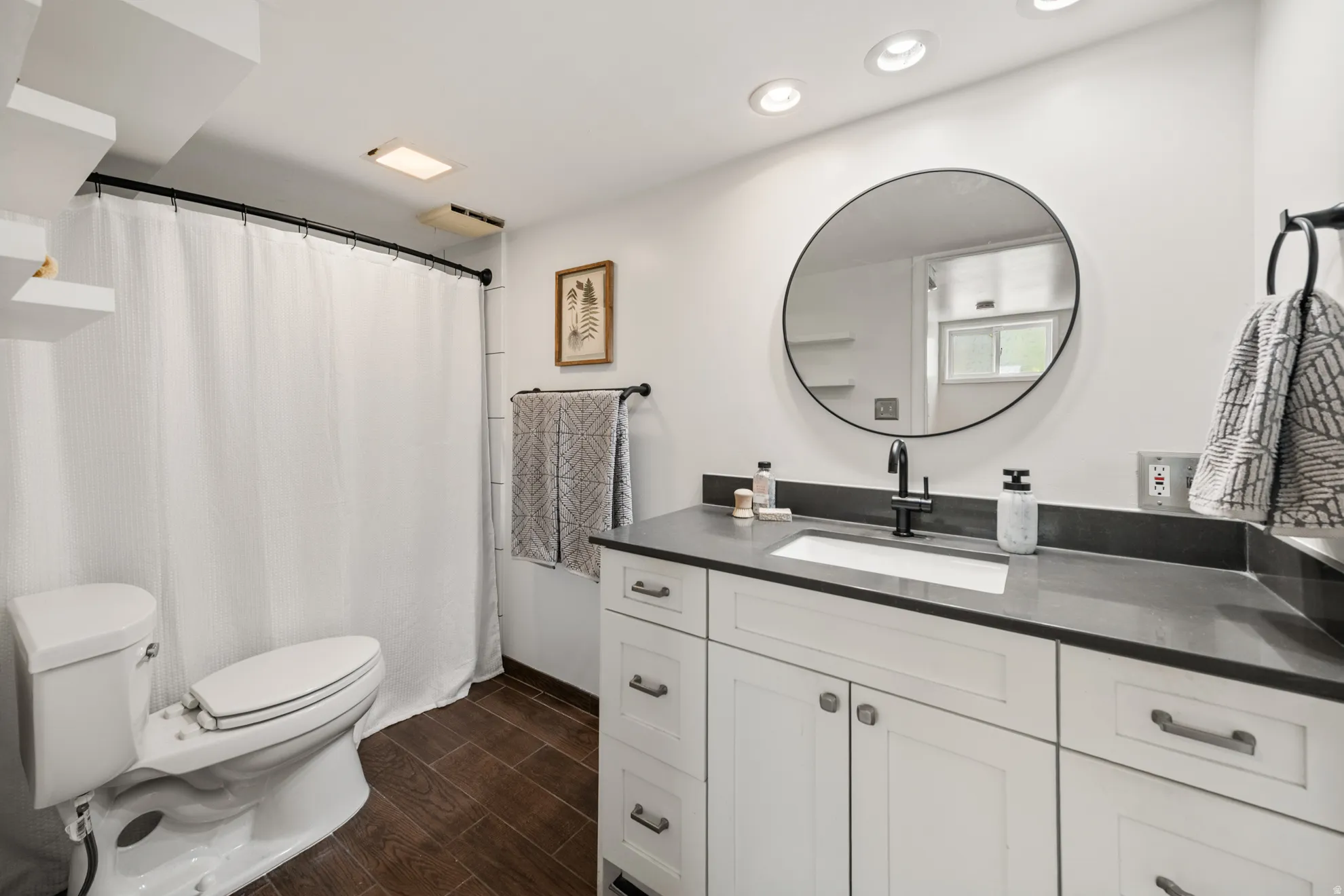 Full bathroom featuring vanity, a shower with curtain, wood tiled floors, and recessed lighting