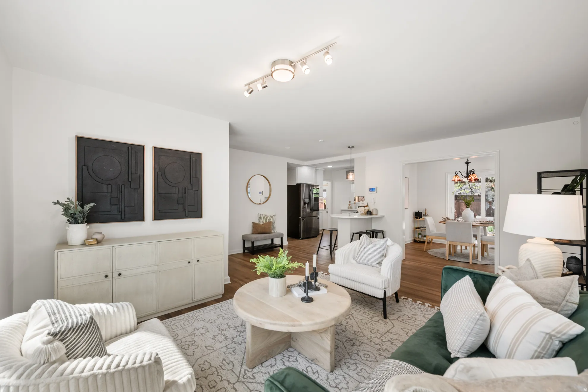 Living room with wood finished floors and track lighting