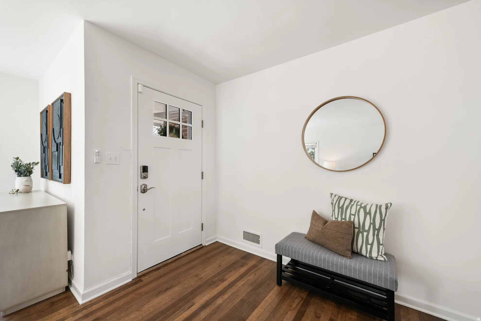 Foyer entrance with baseboards and dark wood-style floors