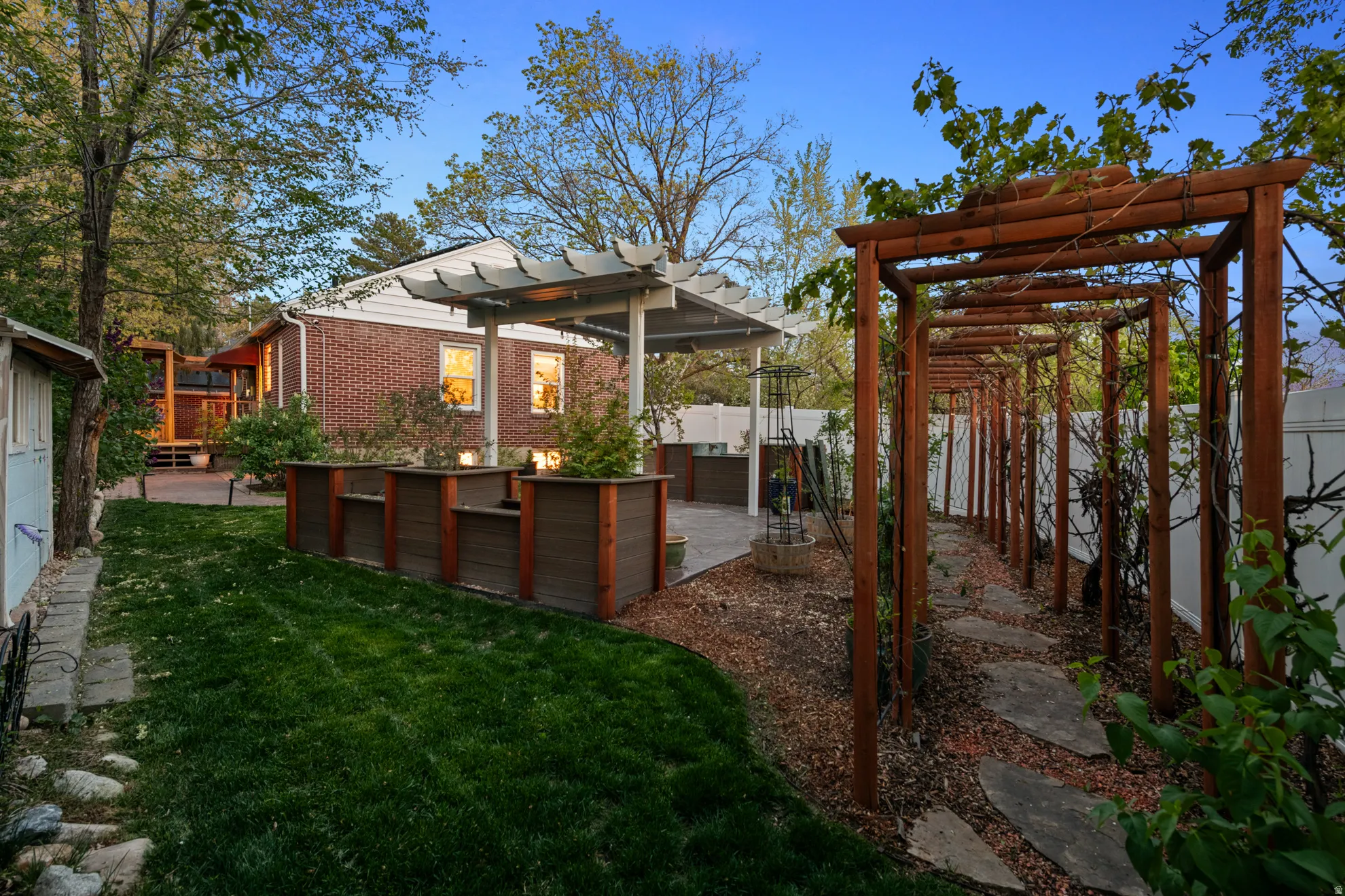 Fenced backyard featuring a pergola and a patio area