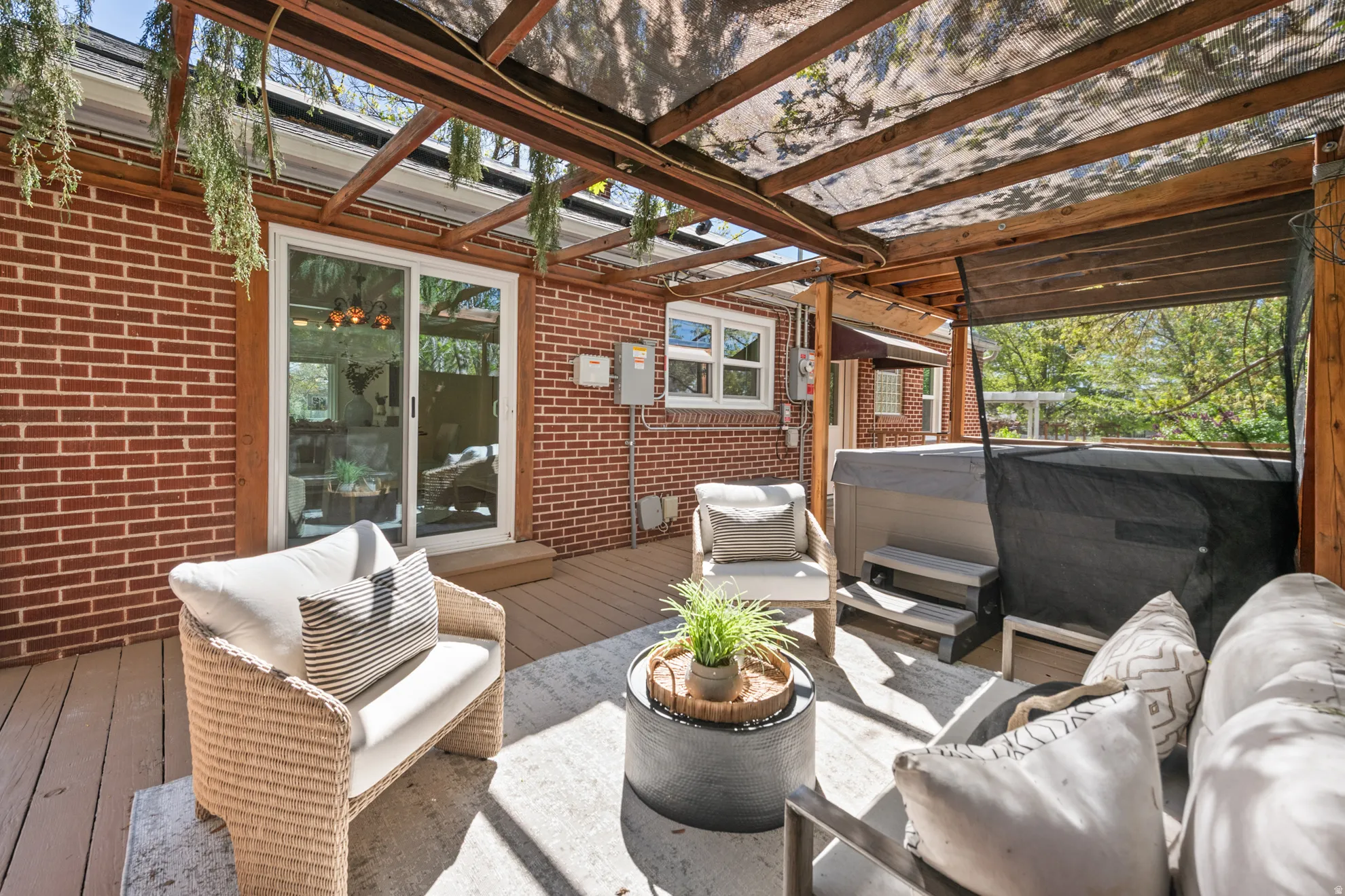 Wooden terrace with an outdoor lounge area and a hot tub