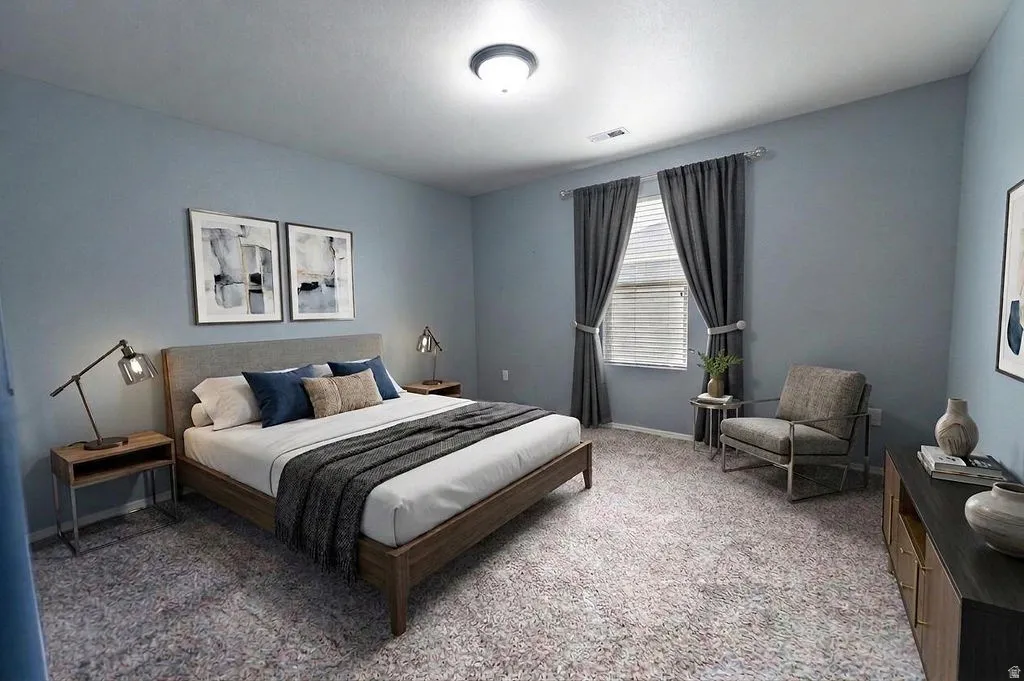 Bedroom featuring light colored carpet and baseboards