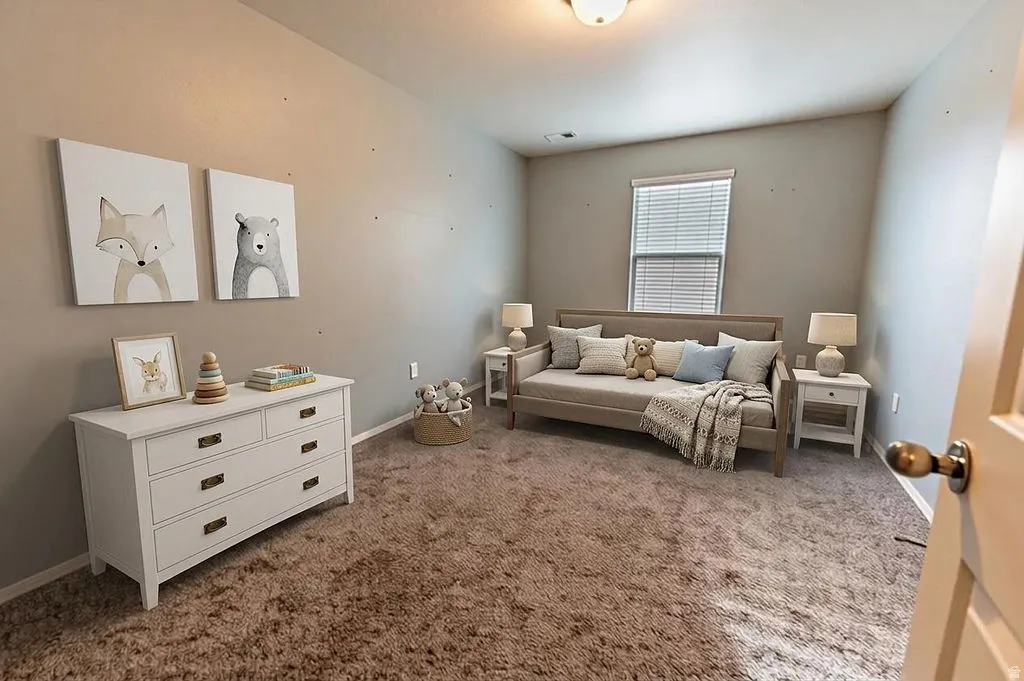 Bedroom featuring dark carpet and baseboards