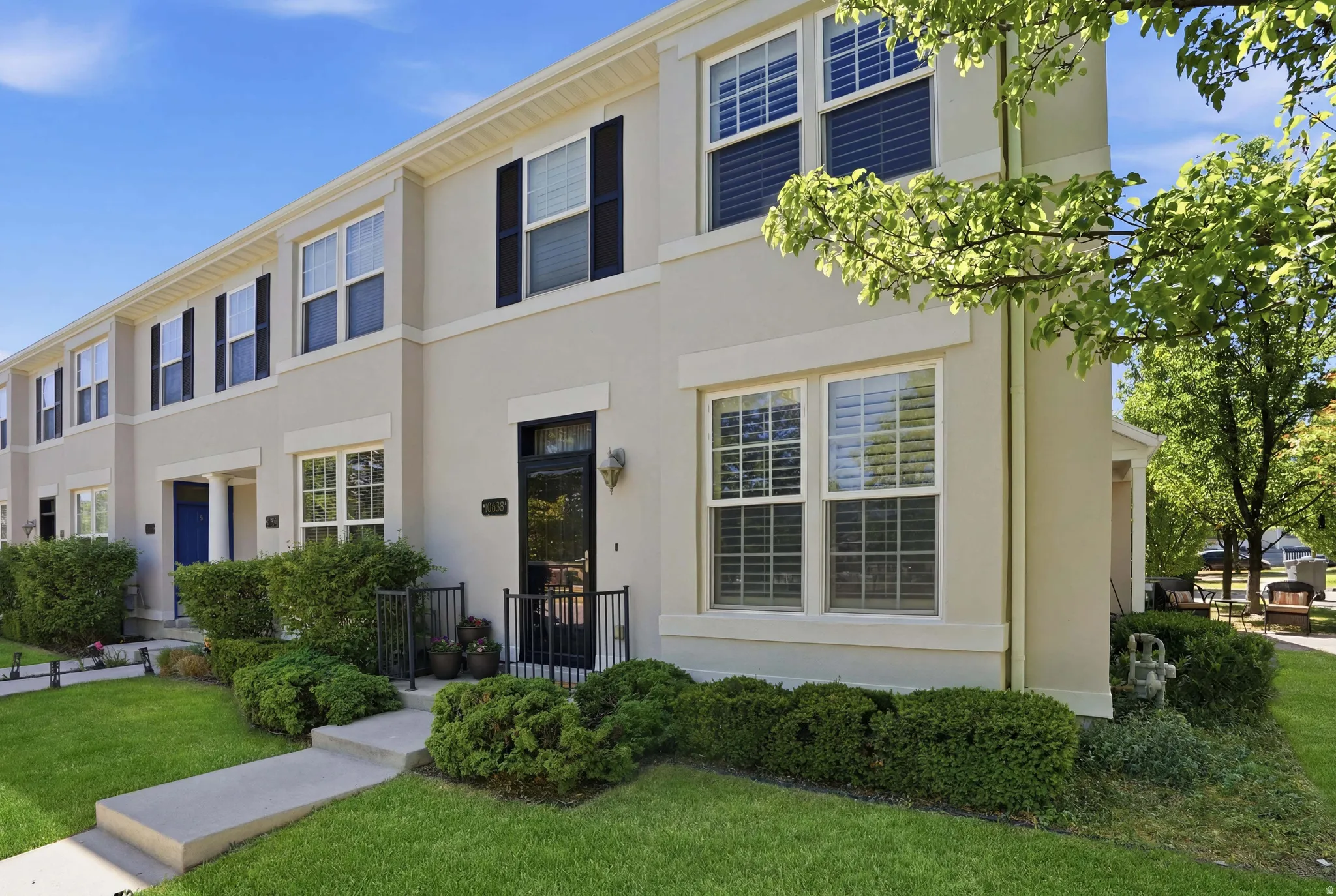 Stucco exterior residence with black shutters