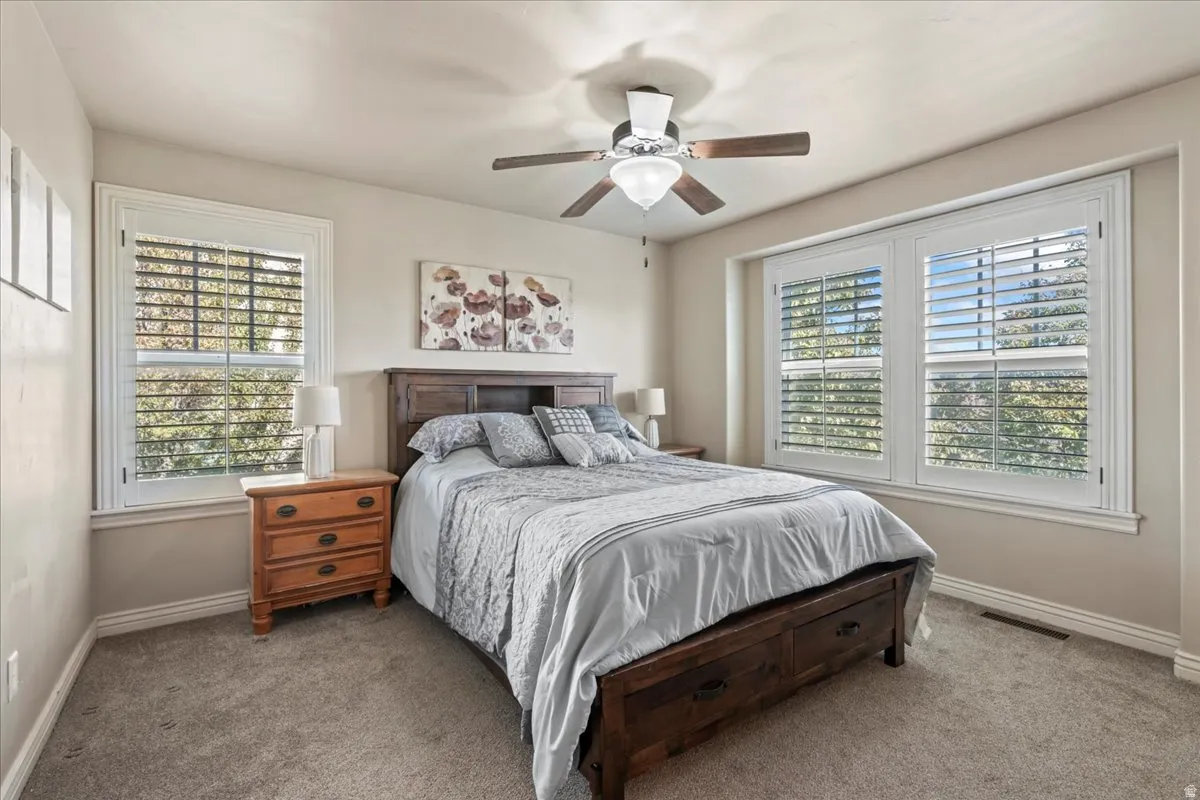 Bedroom featuring carpet and a ceiling fan