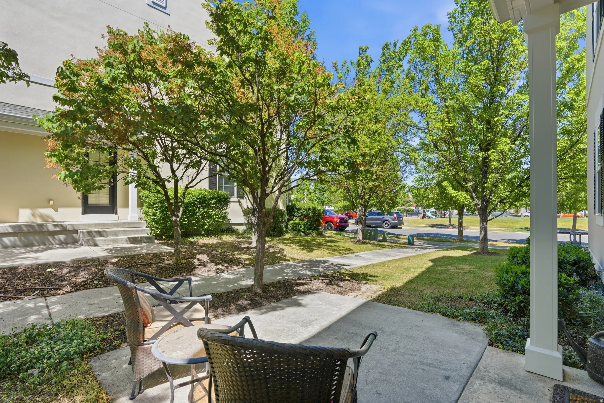 Paved outdoor patio with a partial porch overhang