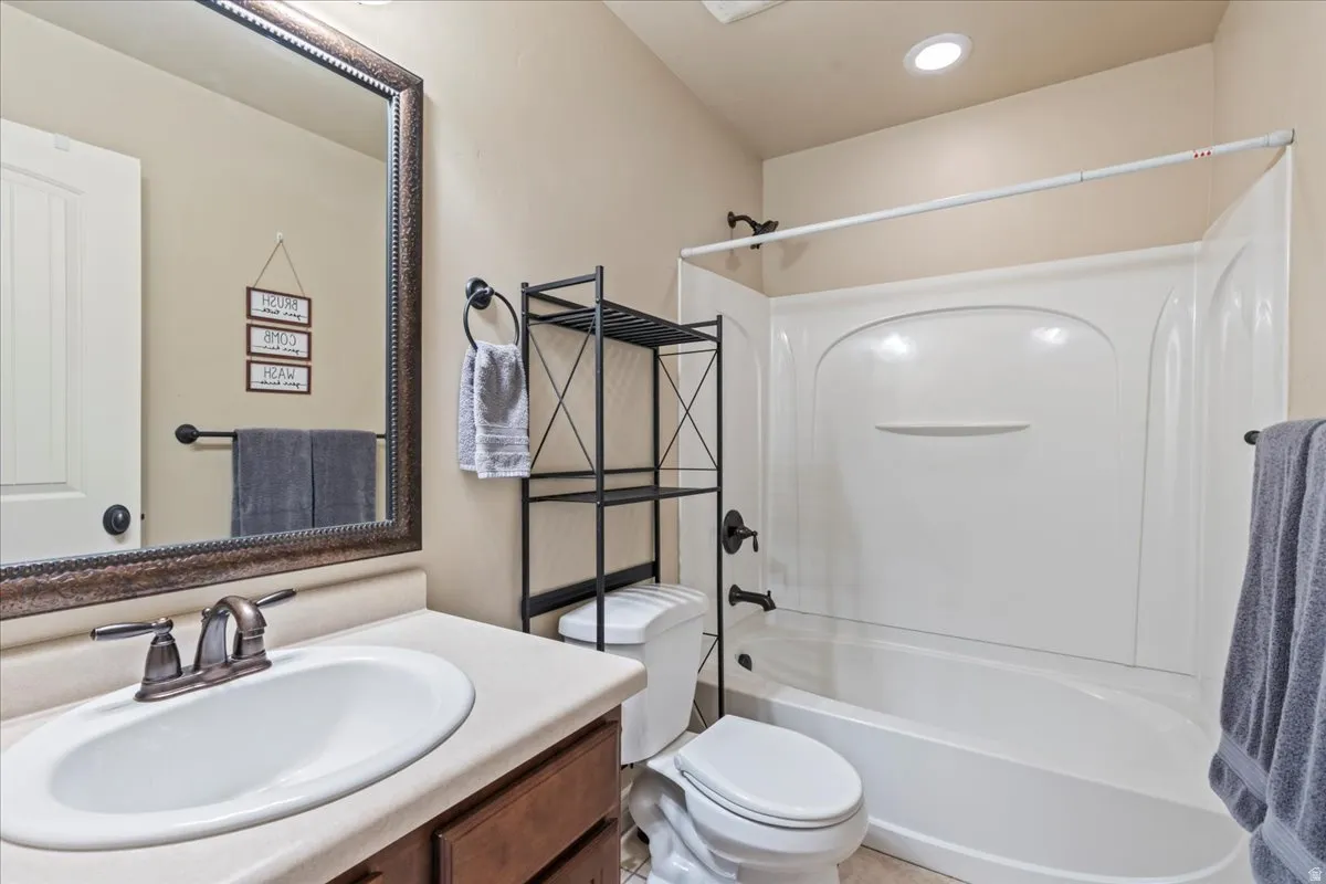 Full bath featuring vanity, tub / shower combination, and recessed lighting