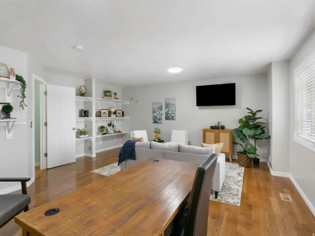 Open-concept living area featuring wood-finish flooring and light gray walls