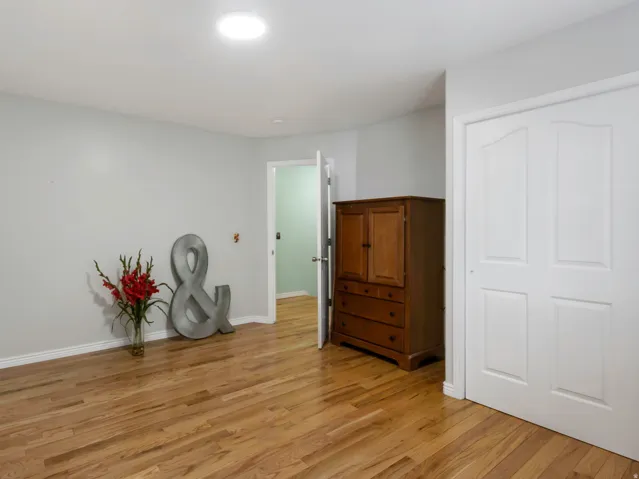 Room featuring wood-finish flooring, light gray walls, white trim, and a white ceiling with recessed lighting