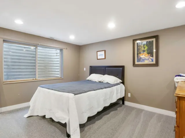 ADU Bedroom featuring recessed lighting illuminates this room, featuring light gray carpeting and tan wall paint